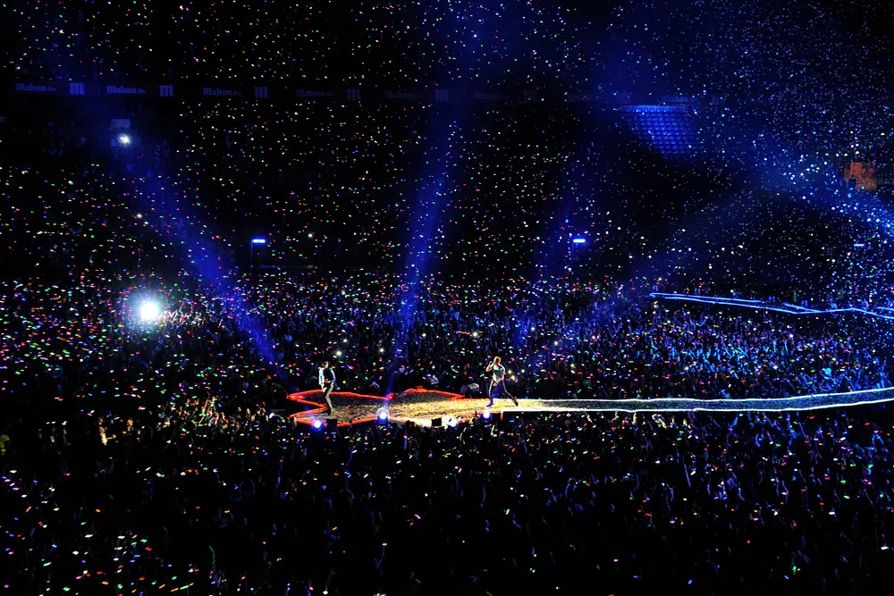 Arena concert attended by performers, audiences and event staff