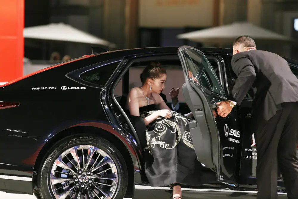 VIP guest arriving at a red carpet event with chauffeur assistance and managed vehicle access