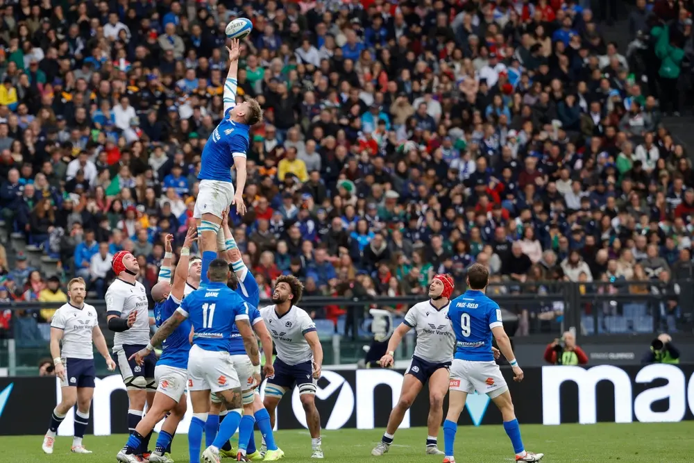 International rugby match taking place in front of a packed stadium crowd