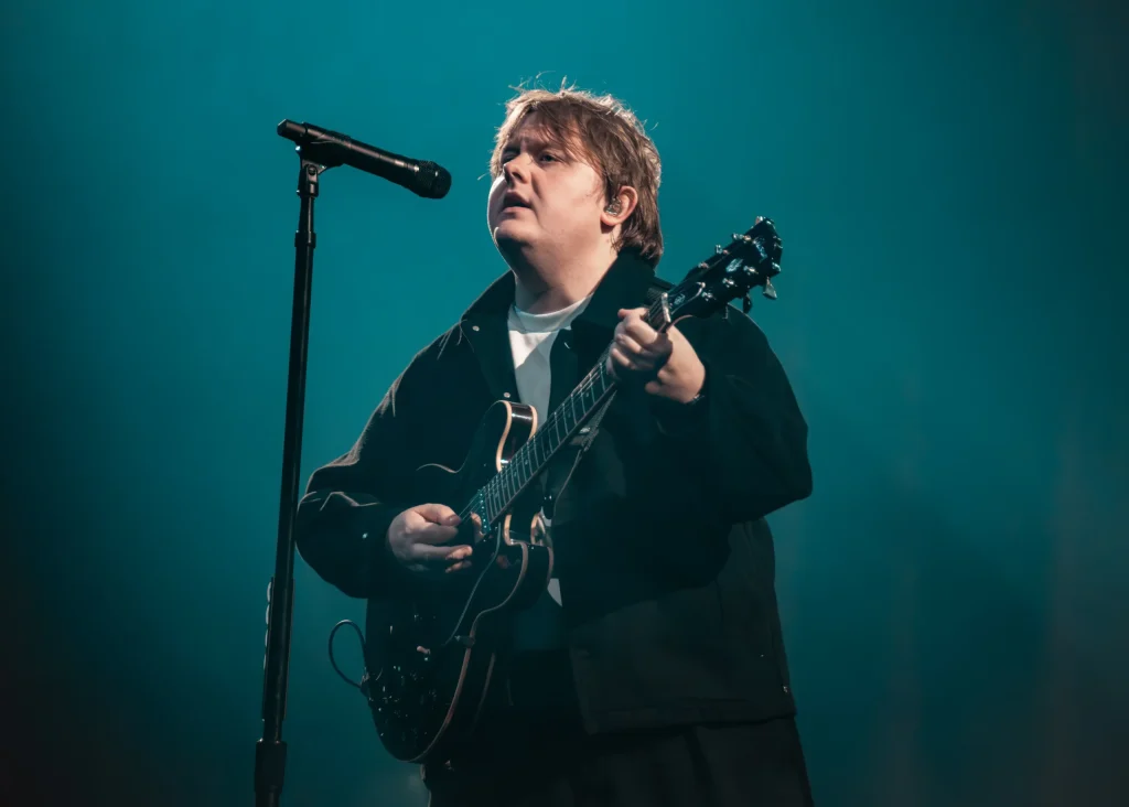Musician performing live on stage during a major concert