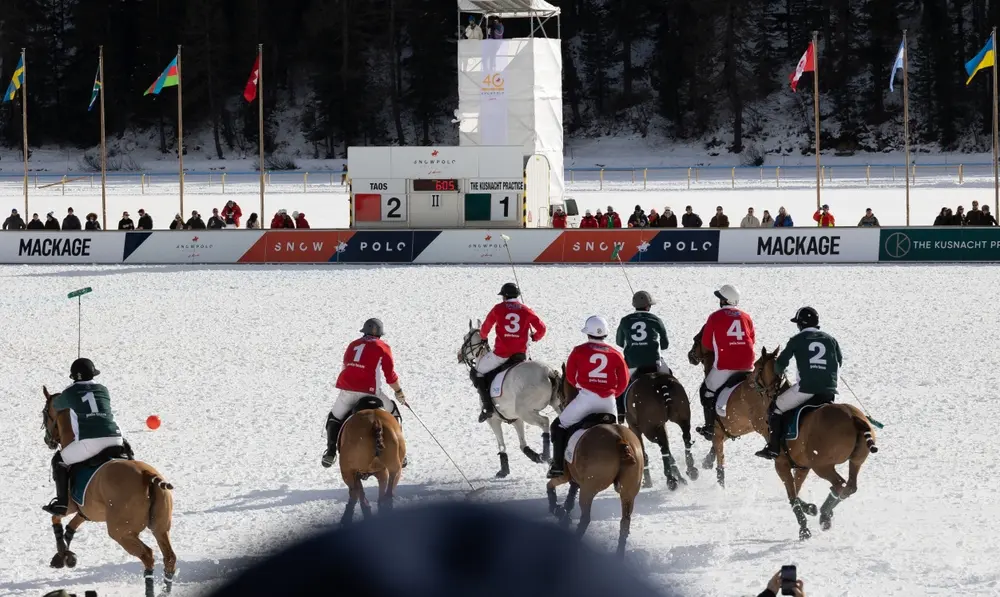 International snow polo match with players competing on a winter polo field